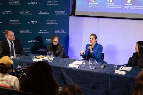Tara Sinclair speaking on a panel stage alongside CCAS Dean Wahlbeck and two faculty members